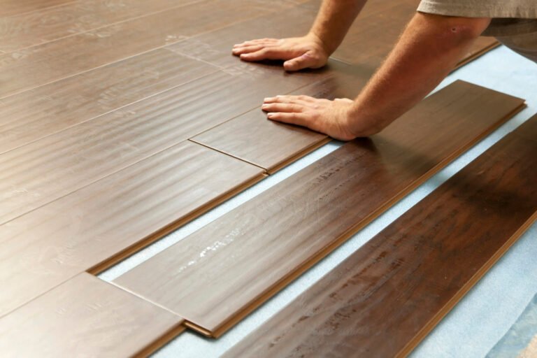 Man installing a laminate parquet flooring