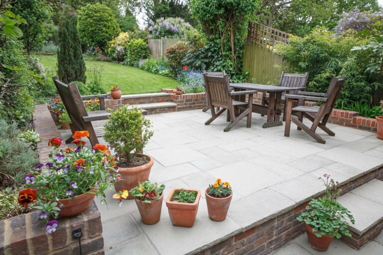 patio at the back of garden with seating's and flower pots
