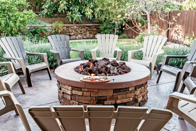 brick circular fire pit with wooden seating chairs