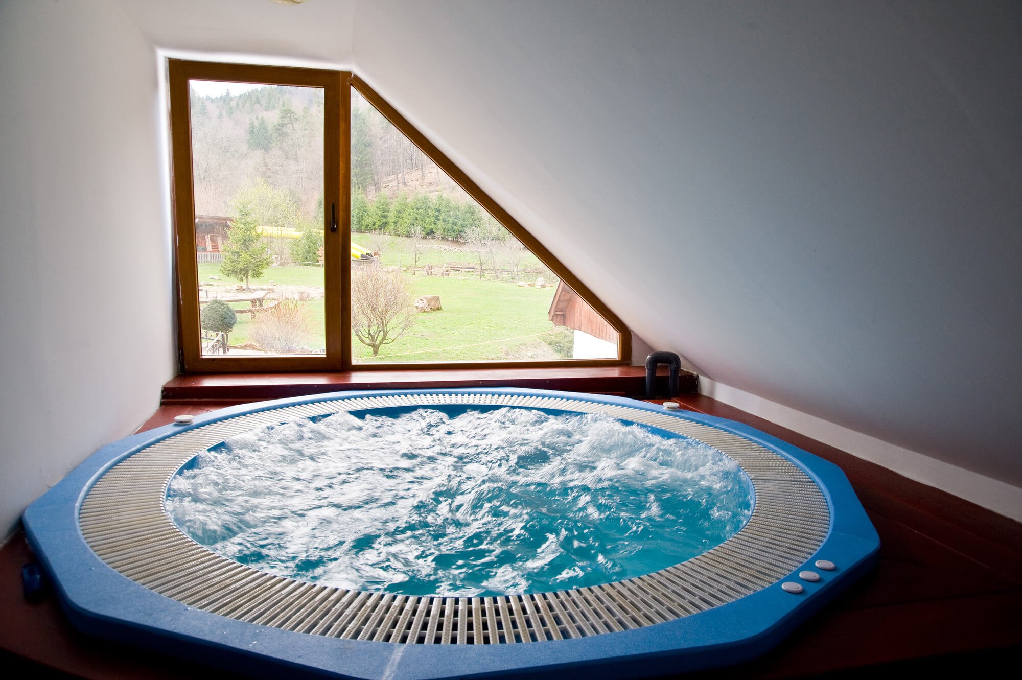 round hot tub in a loft room