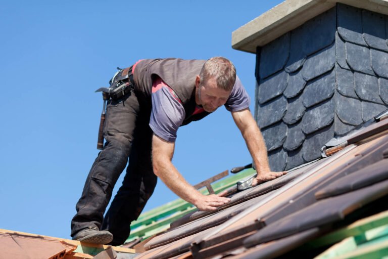 Roofer fixing roof ridge tile