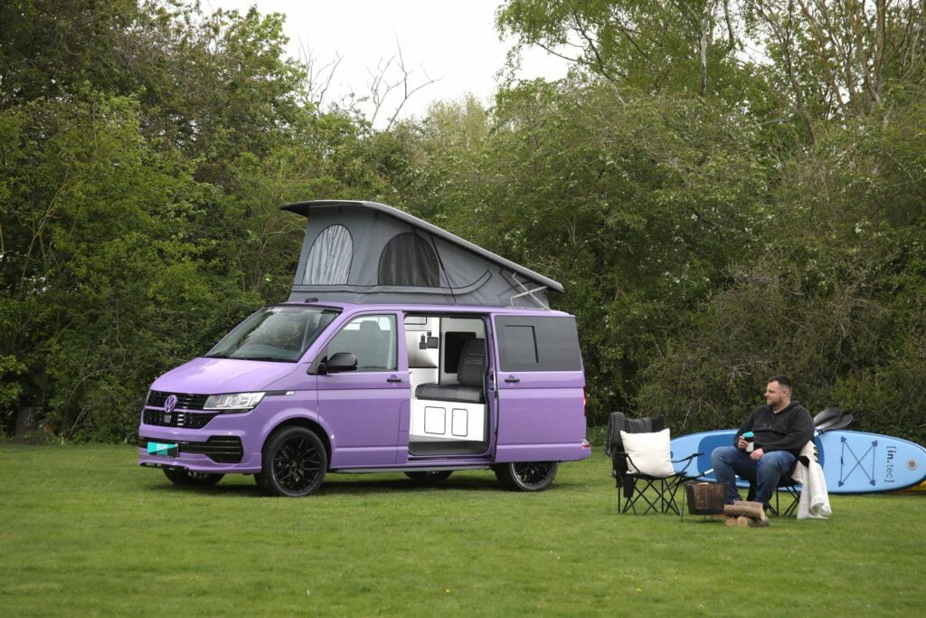Purple Volkswagen campervan with pop up roof